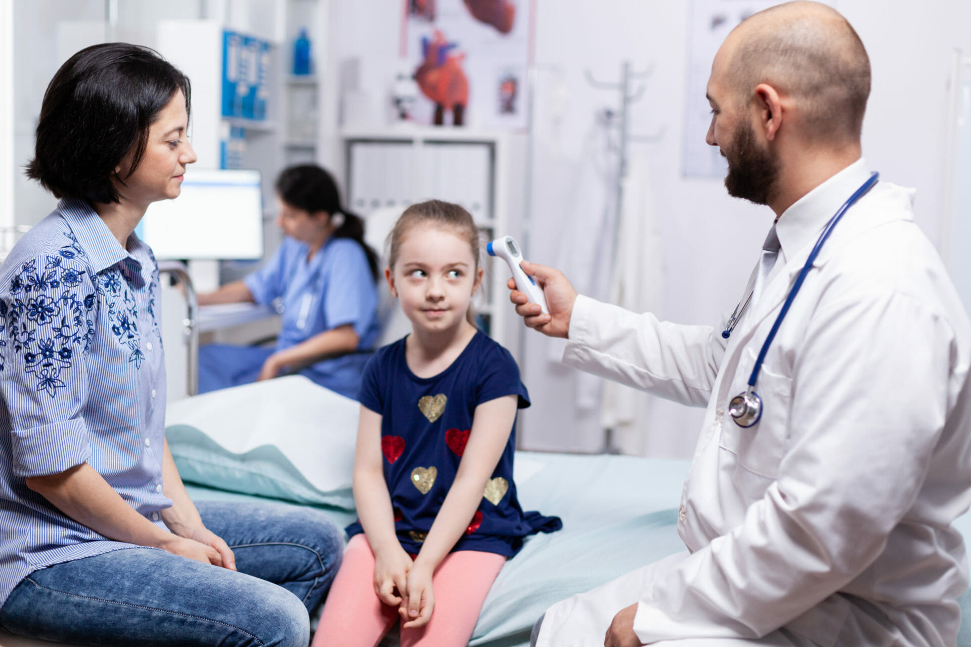 Doctor using digital thermometer